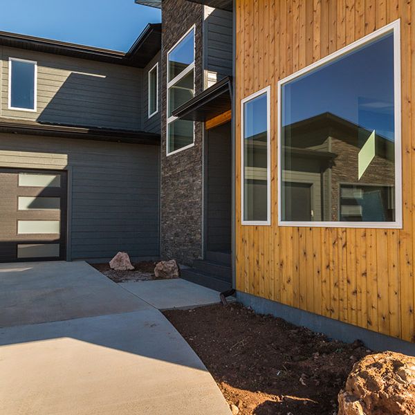 Tamko Roof in Rustic Slate with Smart Side in Smokey Ash accented with 1 x 6 Cedar tongue & groove and  Eldorado Stone